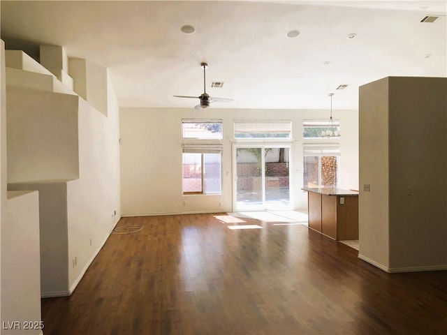 unfurnished living room with ceiling fan and dark hardwood / wood-style floors