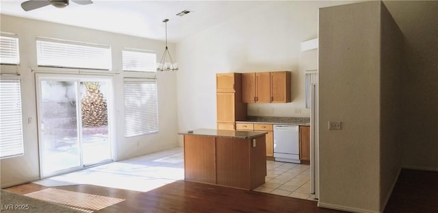 kitchen with a center island, light hardwood / wood-style flooring, white dishwasher, pendant lighting, and ceiling fan with notable chandelier