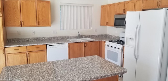 kitchen featuring white appliances and sink