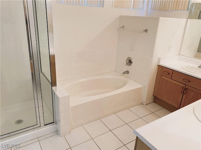 bathroom featuring tile patterned flooring, shower with separate bathtub, and vanity