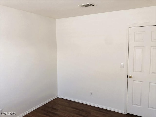 unfurnished room with dark hardwood / wood-style floors