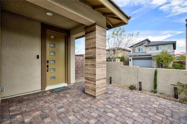 property entrance featuring a patio