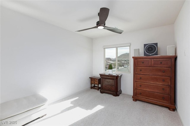 interior space featuring light colored carpet and ceiling fan