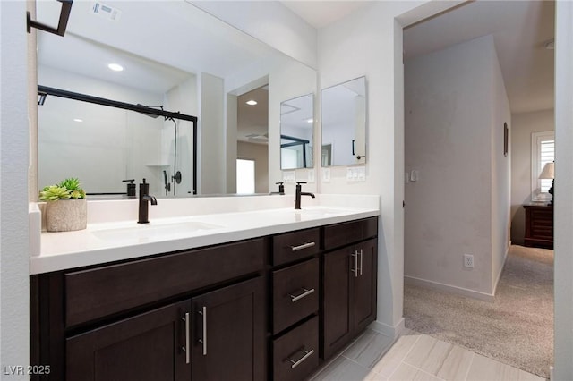 bathroom featuring vanity and a shower with door