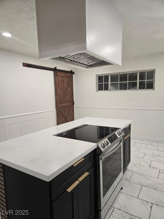 kitchen featuring a barn door, extractor fan, stainless steel electric stove, and a kitchen island