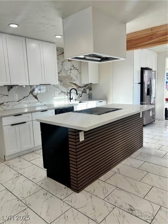 kitchen featuring stainless steel fridge, custom range hood, black electric cooktop, white cabinets, and a center island