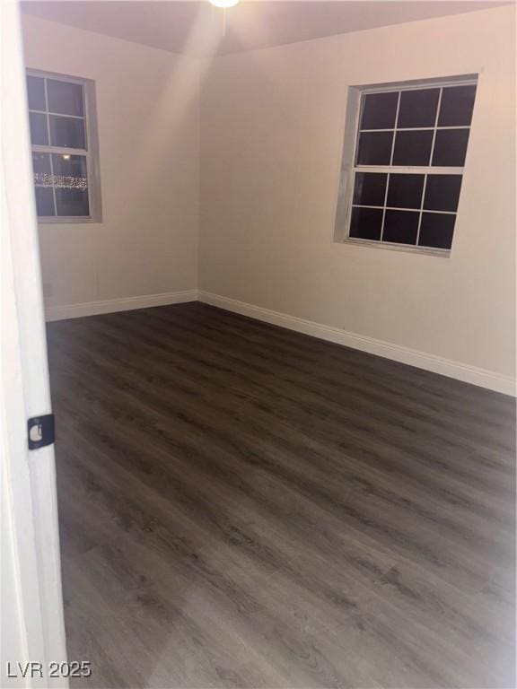 unfurnished room featuring dark hardwood / wood-style flooring