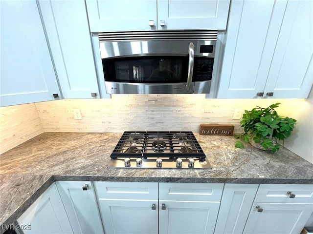 kitchen featuring gas stovetop and tasteful backsplash