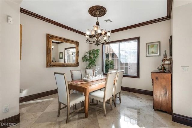 dining room featuring ornamental molding and an inviting chandelier