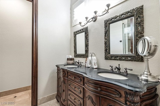 bathroom featuring tile patterned flooring and vanity