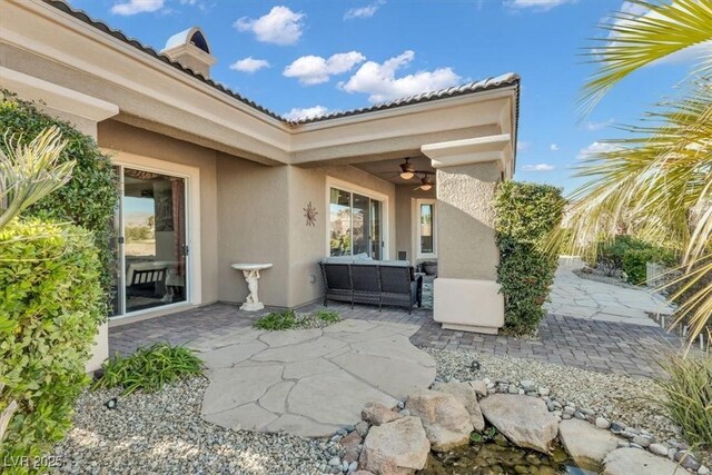 view of patio featuring ceiling fan and an outdoor living space