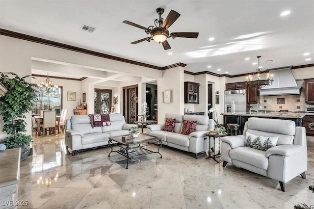 living room with sink and ceiling fan with notable chandelier