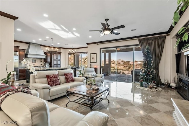 living room with ceiling fan with notable chandelier and ornamental molding