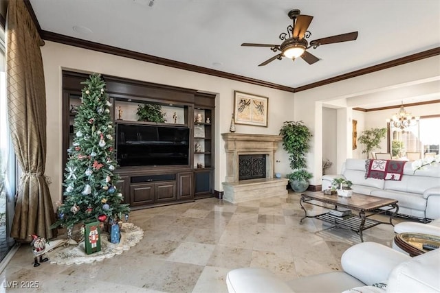 living room with ceiling fan with notable chandelier and ornamental molding