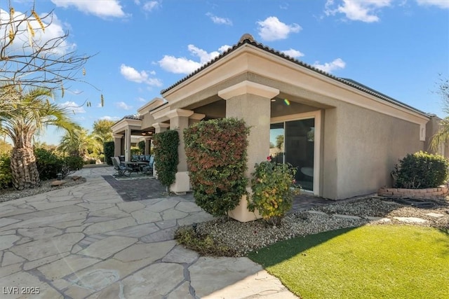 view of side of home featuring a patio area