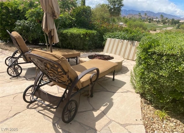 view of patio / terrace featuring a fire pit and a mountain view