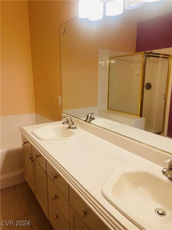 bathroom with shower with separate bathtub, tile patterned floors, and vanity