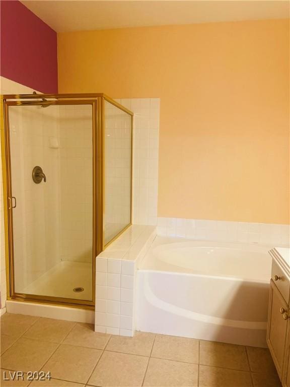 bathroom with independent shower and bath, vanity, and tile patterned floors