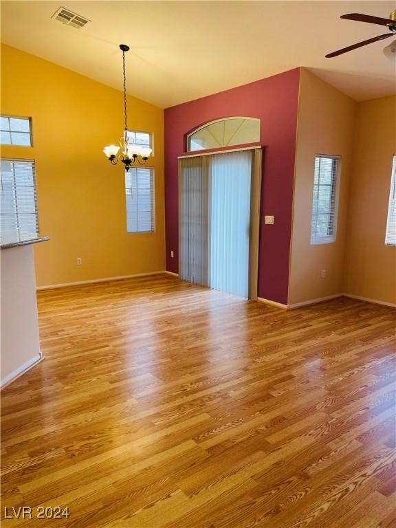 interior space featuring ceiling fan with notable chandelier, lofted ceiling, and hardwood / wood-style floors