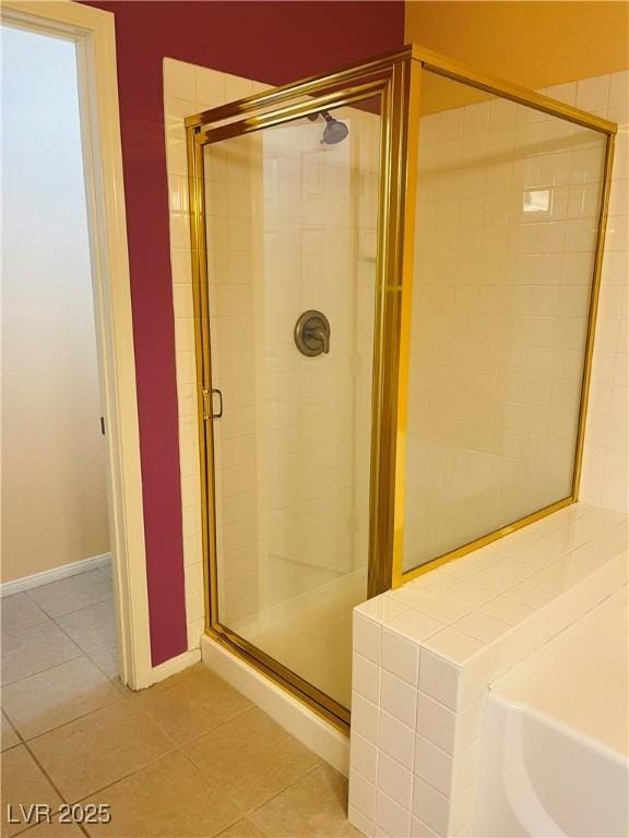 bathroom featuring a shower with shower door and tile patterned flooring