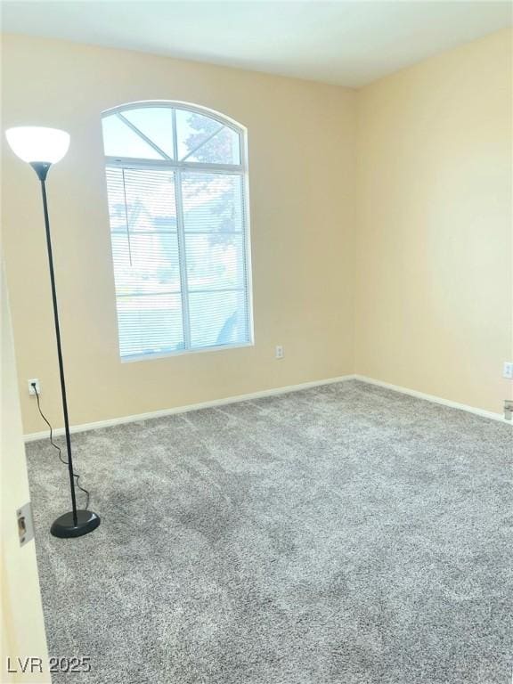 spare room with carpet and baseboards
