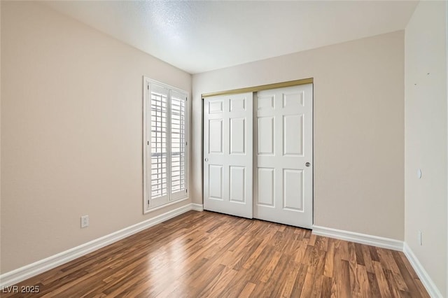 unfurnished bedroom featuring hardwood / wood-style flooring and a closet