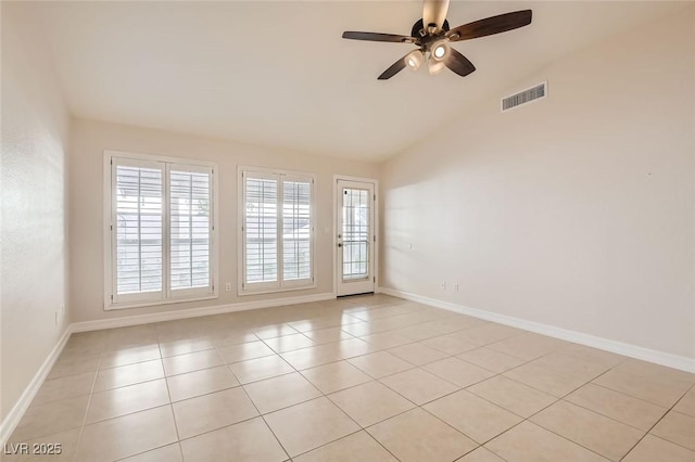 tiled spare room featuring vaulted ceiling and ceiling fan