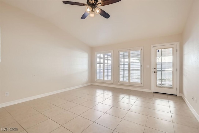 empty room featuring light tile patterned floors, ceiling fan, and lofted ceiling