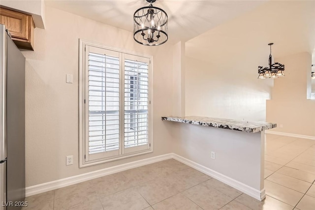 unfurnished dining area with light tile patterned flooring and an inviting chandelier