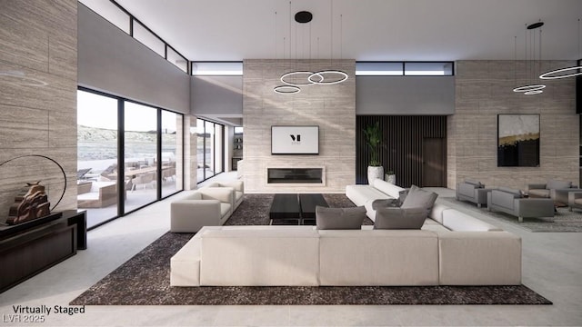 living room featuring a tile fireplace and a high ceiling