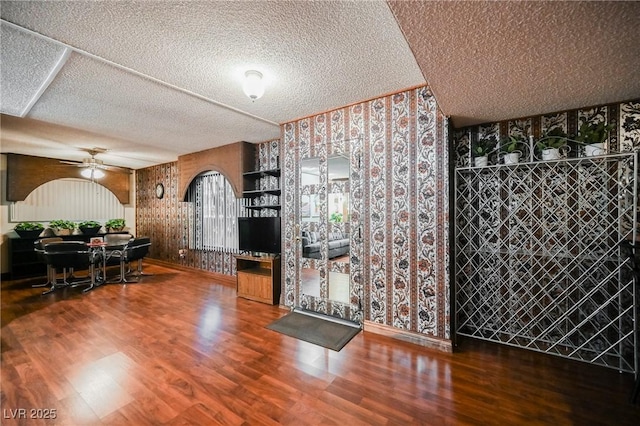 dining room featuring ceiling fan, a textured ceiling, and hardwood / wood-style flooring