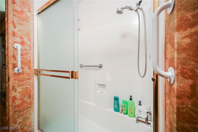 bathroom with a shower with shower door