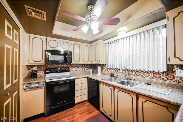 kitchen with ceiling fan, sink, dark hardwood / wood-style floors, decorative backsplash, and black appliances