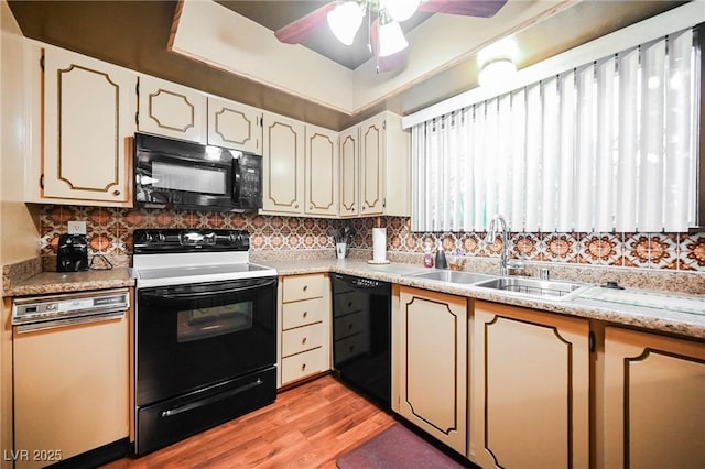 kitchen with black appliances, sink, ceiling fan, decorative backsplash, and light wood-type flooring