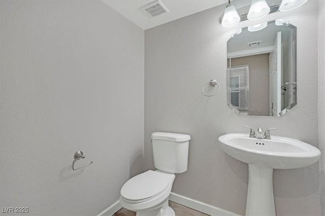 bathroom featuring sink and toilet