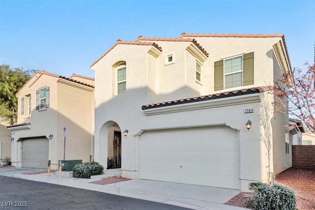 mediterranean / spanish house with a garage and central AC