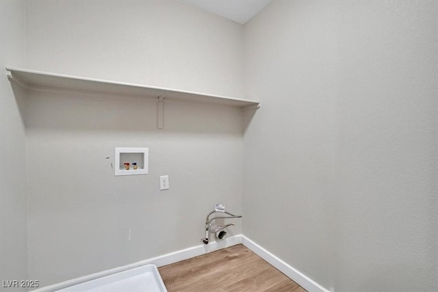 clothes washing area featuring hookup for a gas dryer, hardwood / wood-style floors, and washer hookup