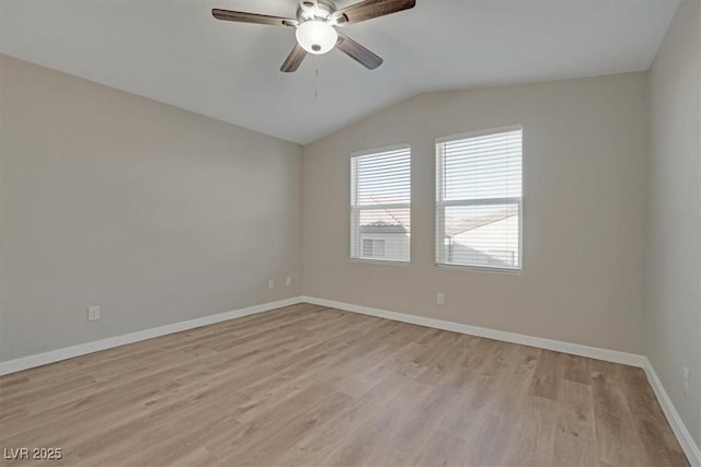 spare room with ceiling fan, light hardwood / wood-style flooring, and vaulted ceiling