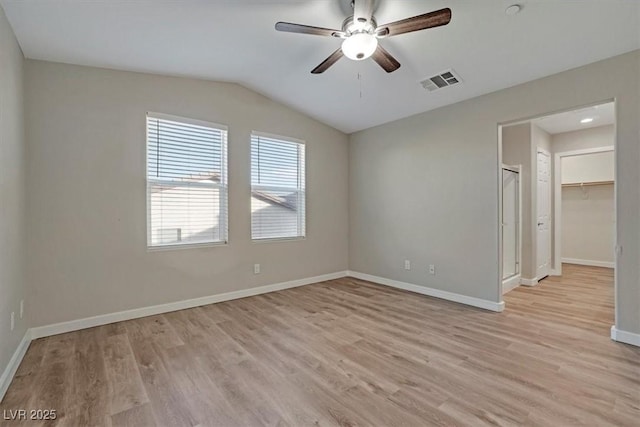 unfurnished room with light wood-type flooring, ceiling fan, and lofted ceiling