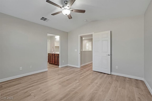 unfurnished bedroom with light hardwood / wood-style floors, ensuite bath, ceiling fan, and lofted ceiling