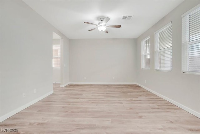 unfurnished room with ceiling fan and light wood-type flooring