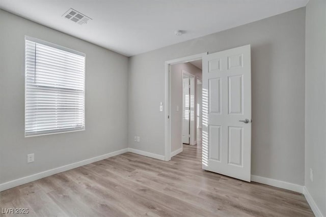 spare room featuring light wood-type flooring