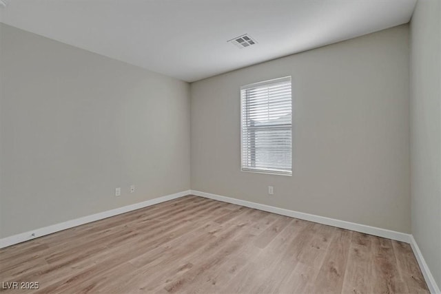 unfurnished room with light hardwood / wood-style flooring