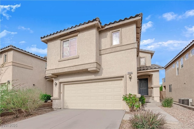 view of front of home featuring a garage and central AC