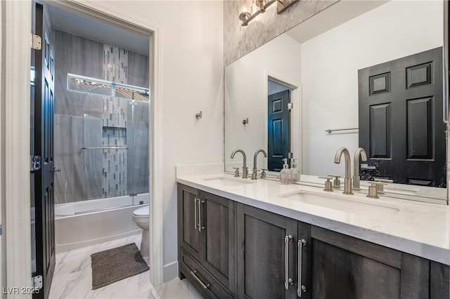 full bathroom featuring vanity, enclosed tub / shower combo, and toilet