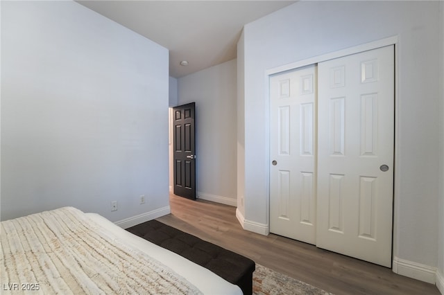 bedroom featuring a closet and dark hardwood / wood-style floors