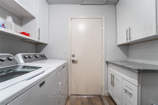 laundry room with washing machine and dryer and cabinets