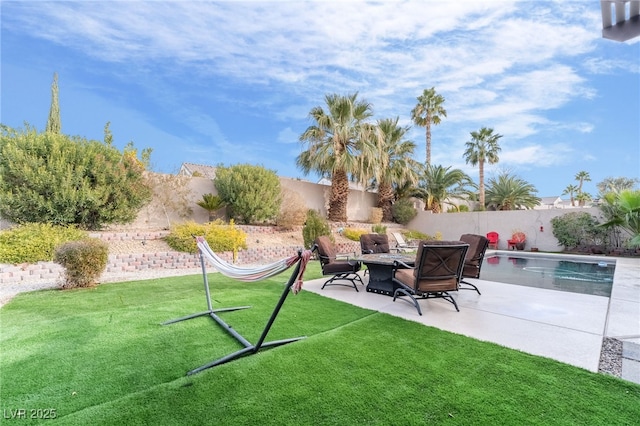 view of yard featuring a fire pit, a fenced in pool, and a patio