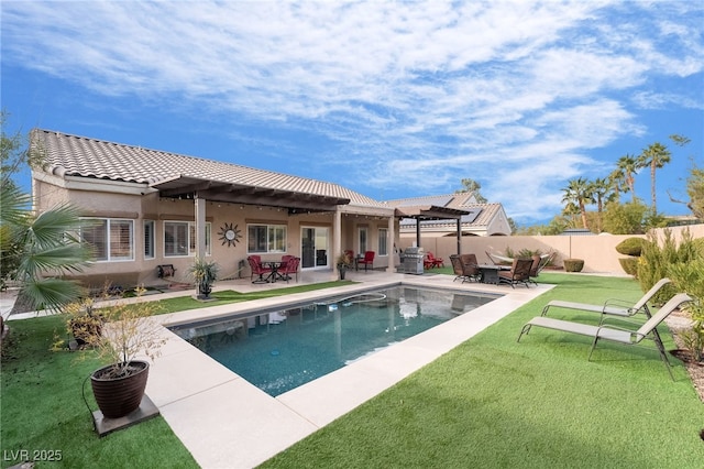 back of house with a fenced in pool, a patio area, and a yard