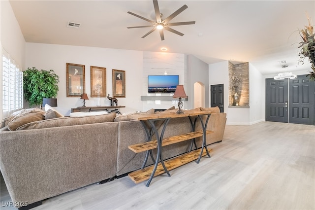 living room featuring ceiling fan, hardwood / wood-style floors, and lofted ceiling